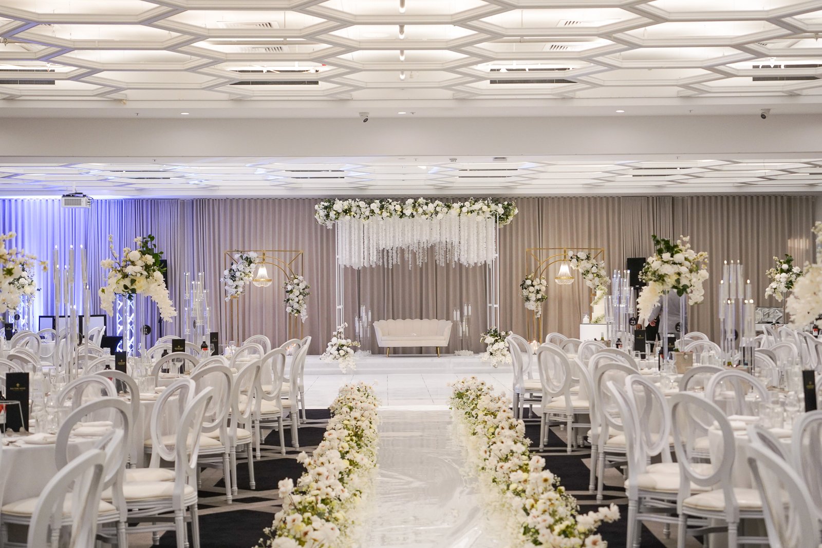 Silk flower decorated wedding stage with fairy tale aisle